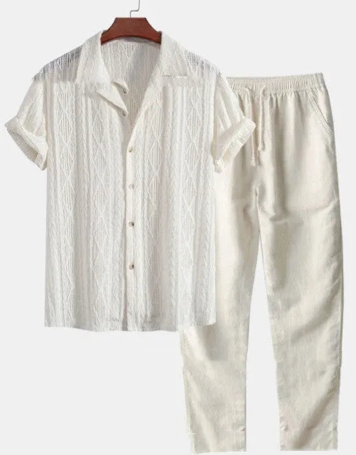 Man wearing a loose-fitting short sleeve shirt and trousers from a milk silk summer suit set.