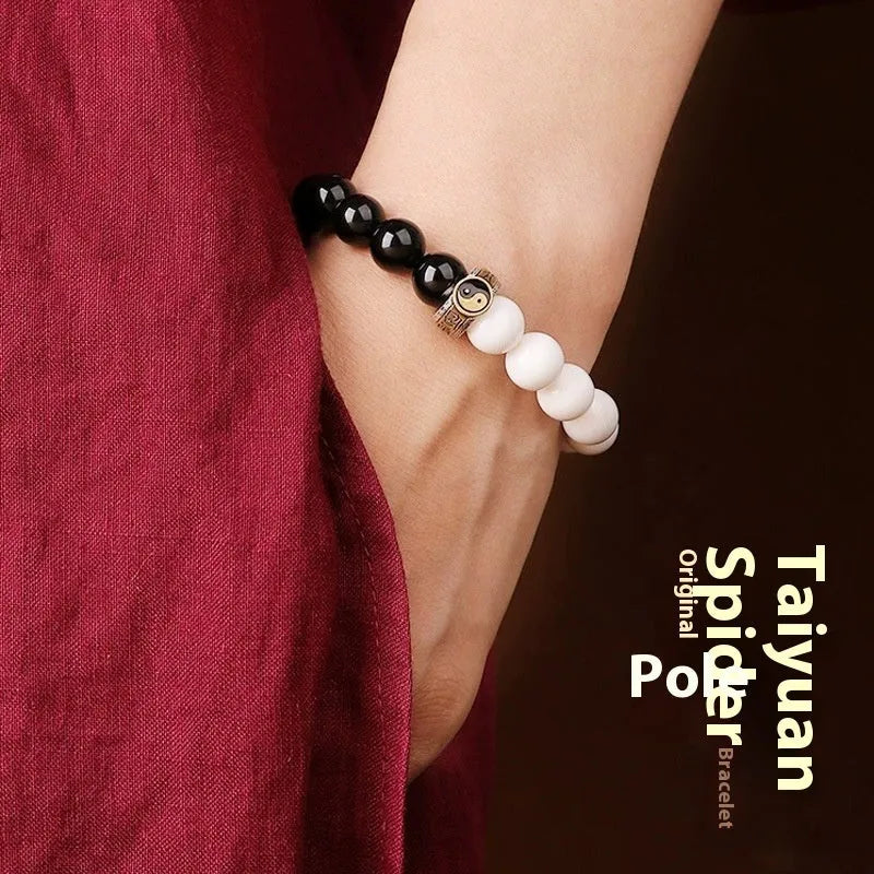 Black and white obsidian bracelet with taiji symbol and geometric beads