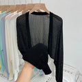 Women's apricot coloured blouse with long, loose lantern sleeves and hollow-out fabric detail.