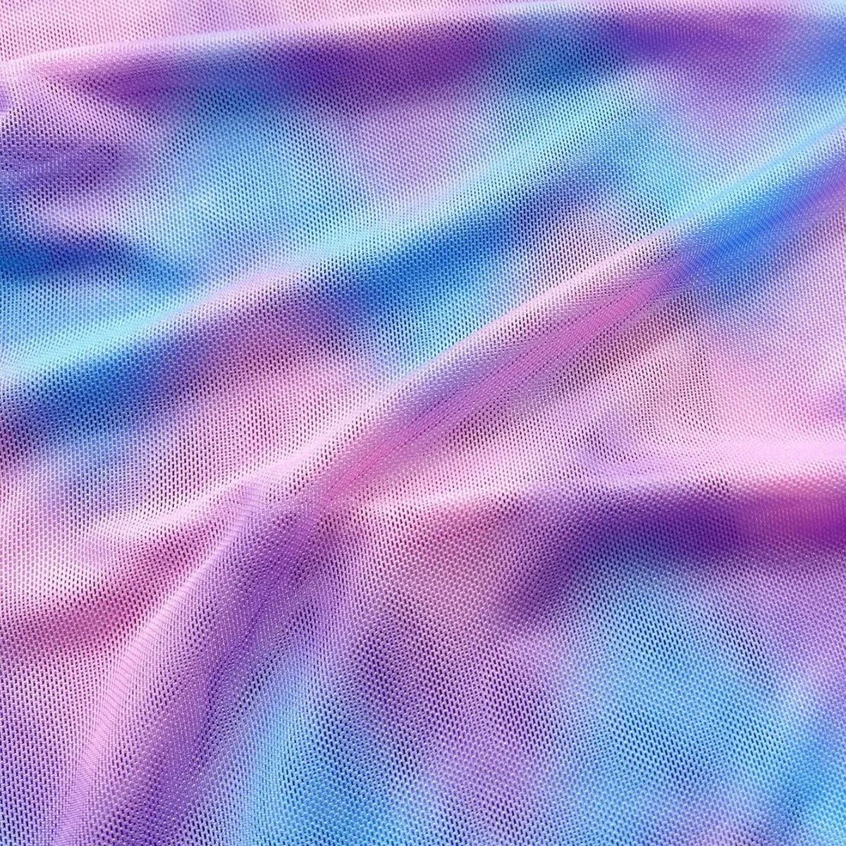 Women's tie-dye patterned bikini swimsuit with a removable skirt, showing bra top and briefs.