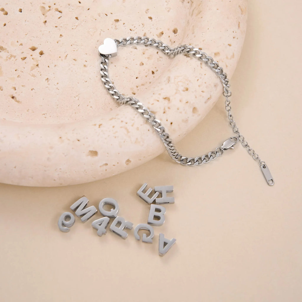 Titanium steel necklace with 40.5cm chain and electroplated gold charms showing numbers and letters for personalisation