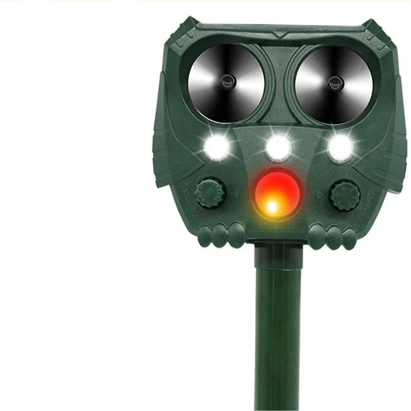 Green solar ultrasonic dog repeller with solar panel, measuring 12x13x5cm for outdoor pest control