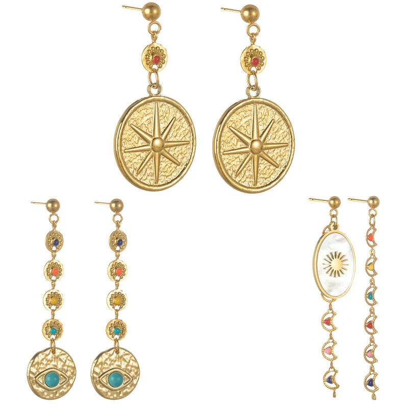 Three pairs of geometric stainless steel earrings showing Eight Awn Star, Eye, and Shell Sun designs.