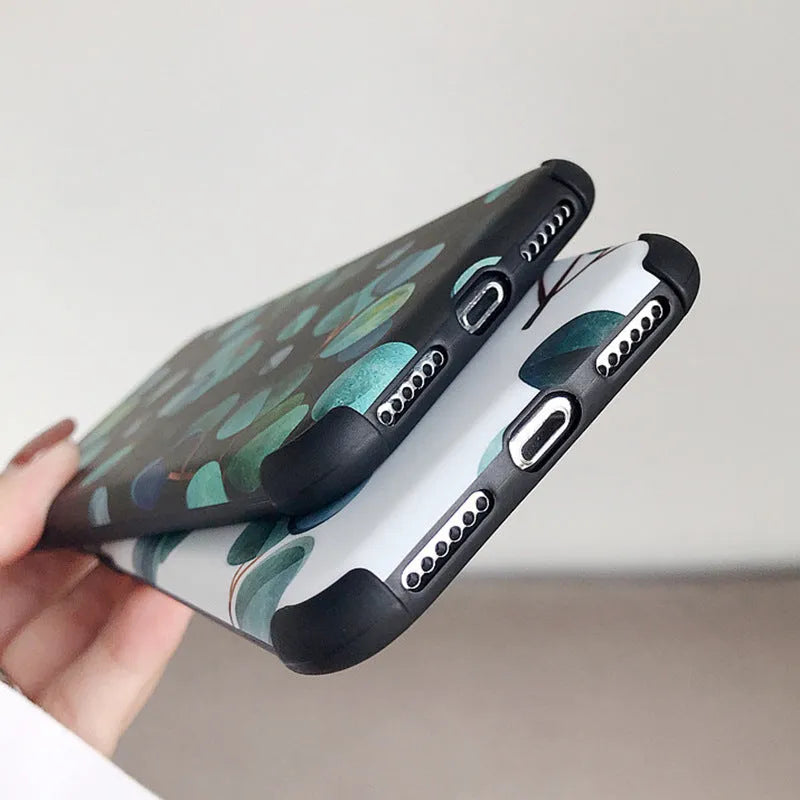 Black silicone iPhone case with a green leaf and botanical floral print design.