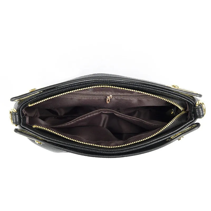 Leather niche pleated shoulder crossbody bag in black with horizontal square shape, multiple interior pockets and soft composite leather.