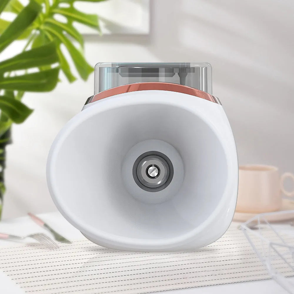 White and purple personal eye humidifier device with USB charging cable on a table.
