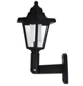 Black hexagonal solar-powered LED wall light for outdoor garden use.