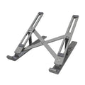 Silver aluminium laptop stand with six-height adjustment gears beside a black laptop on a desk