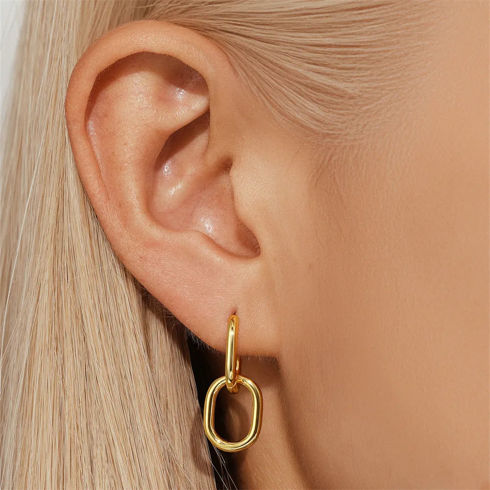Geometric brass earclip earrings with electroplated golden finish and round elements