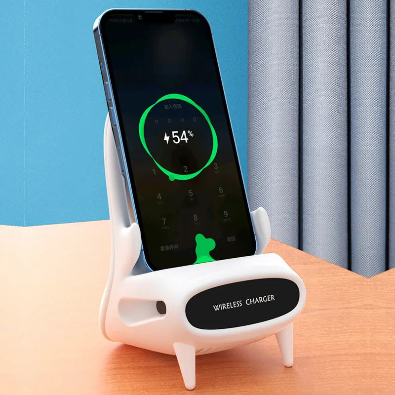 White mini chair shaped wireless charging stand holding smartphone on desk