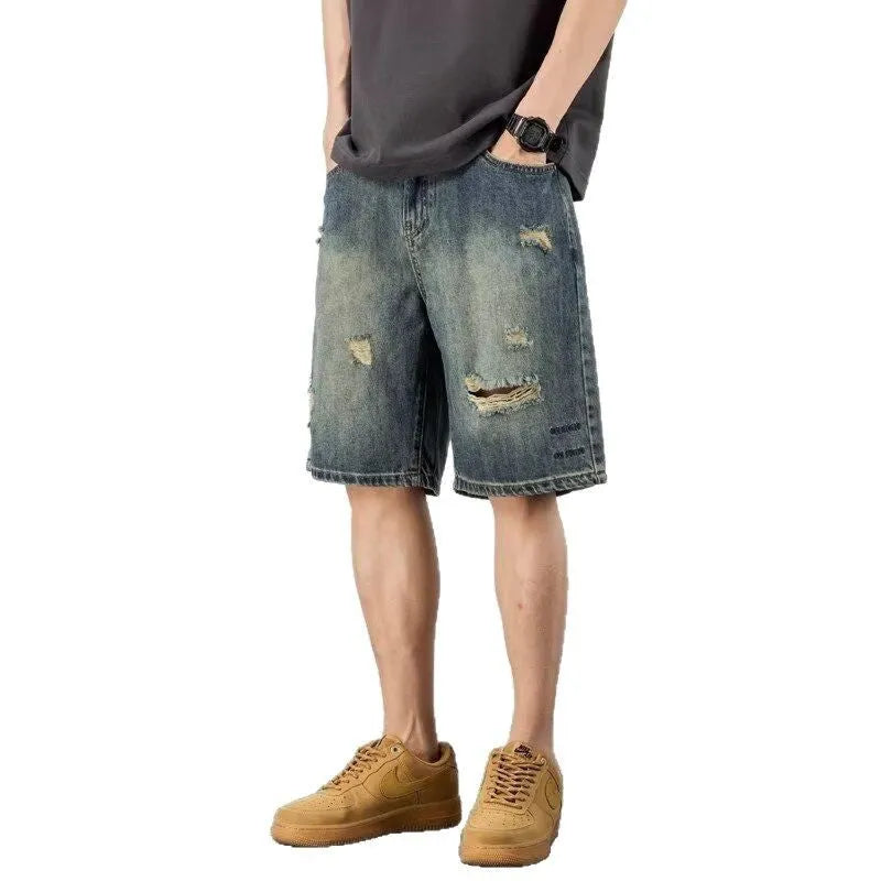 Blue retro-style men's denim shorts with a straight leg and slight distressing details on a neutral background.