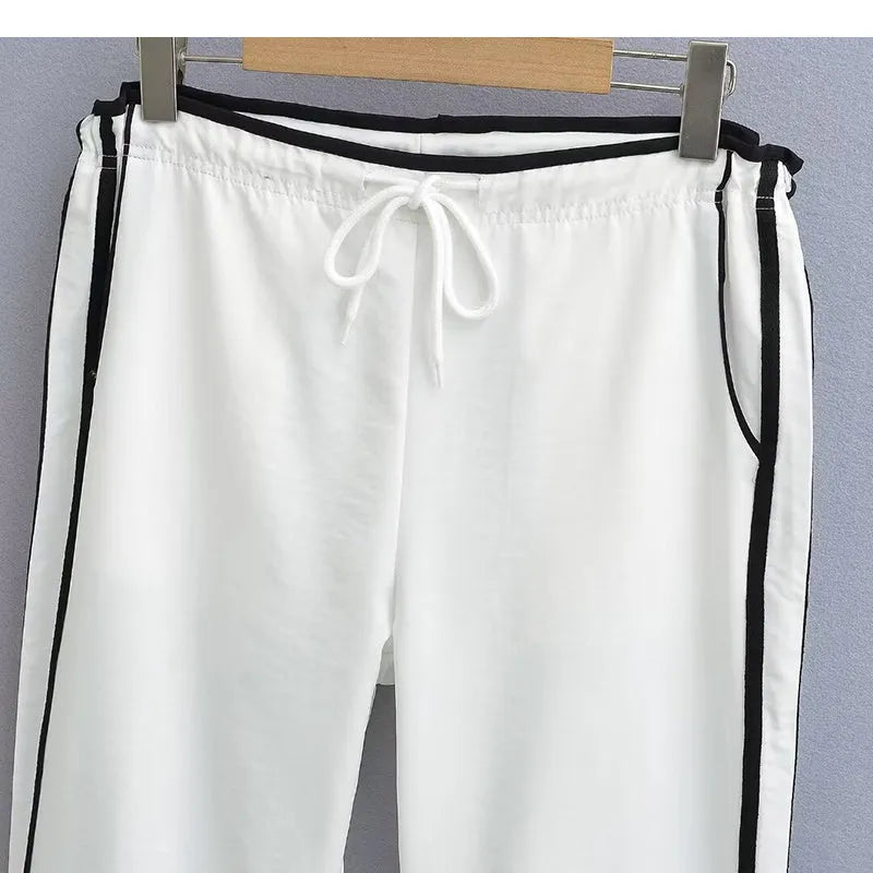 Women's loose straight-leg trousers with ribbon contrast detail in white and navy blue.