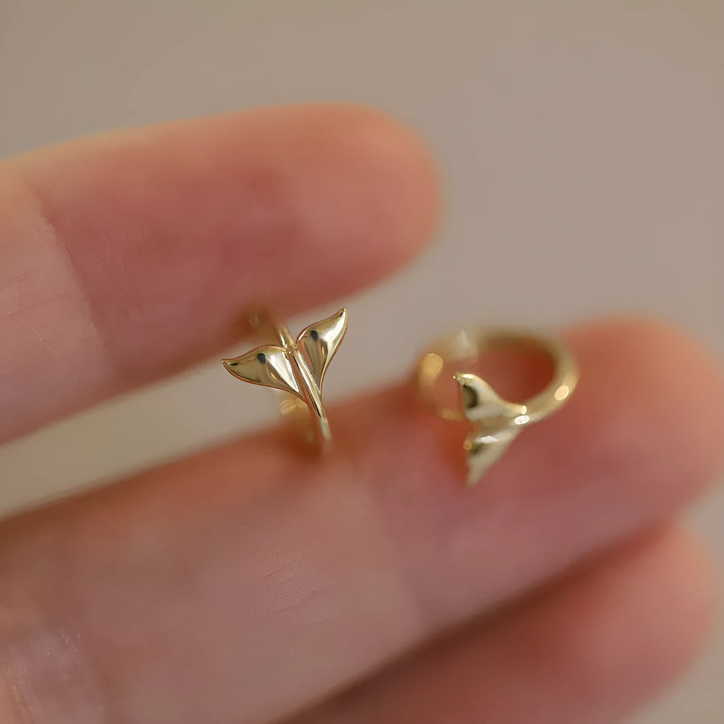 Pair of smooth fishtail earrings in gold or white gold plating, made from 925 sterling silver, showing simple design.