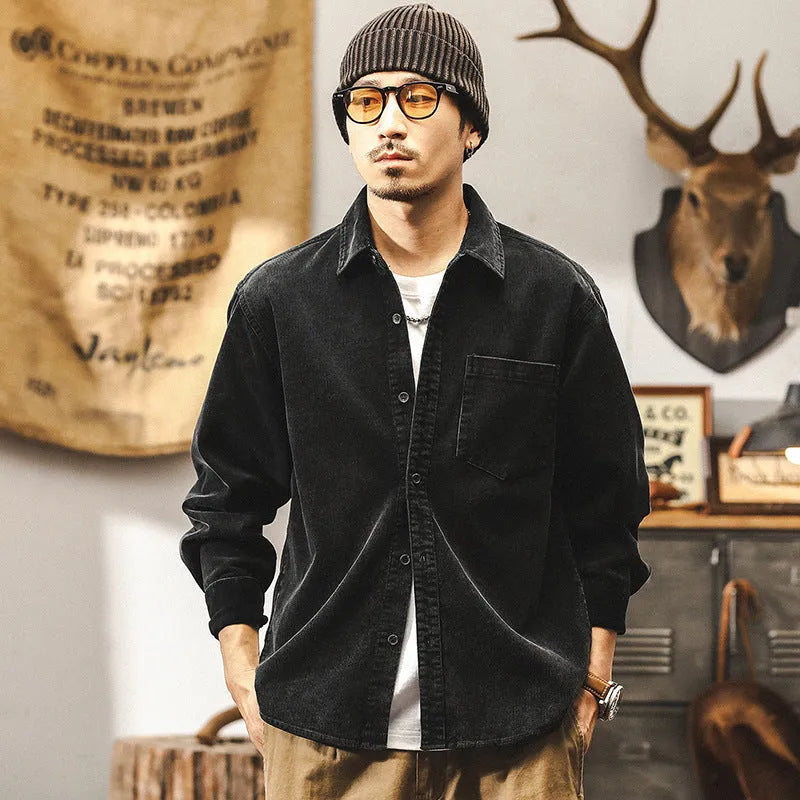 Men's red corduroy shirt jacket with loose fit design and long sleeves on hanger