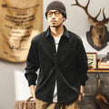 Men's red corduroy shirt jacket with loose fit design and long sleeves on hanger