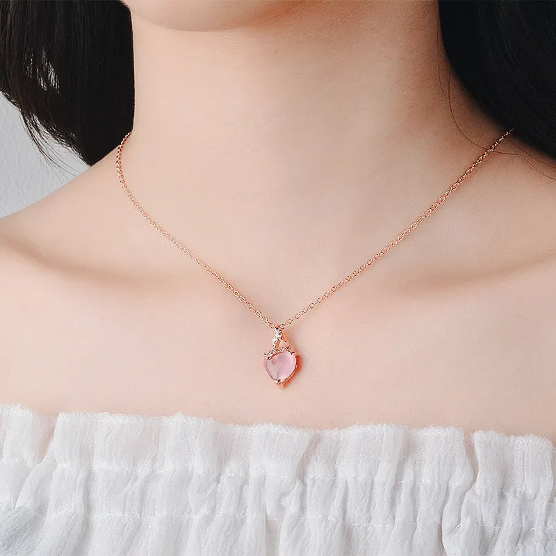 Women's heart-shaped pink crystal pendant necklace on rose gold cross chain