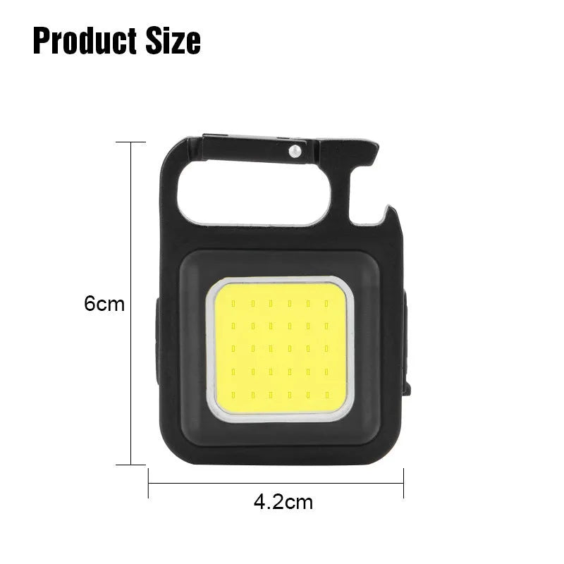 Black aluminium alloy keychain light with magnetic base and foldable handle, measuring 6 cm by 4.2 cm