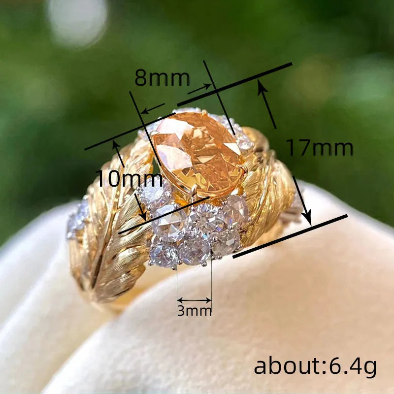 Gold-colour copper embossed feather ring with inlaid yellow zircon, shown in UK size 8
