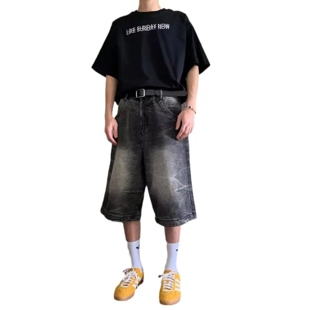 Man wearing loose light blue washed denim cowboy shorts with a straight-leg cut.