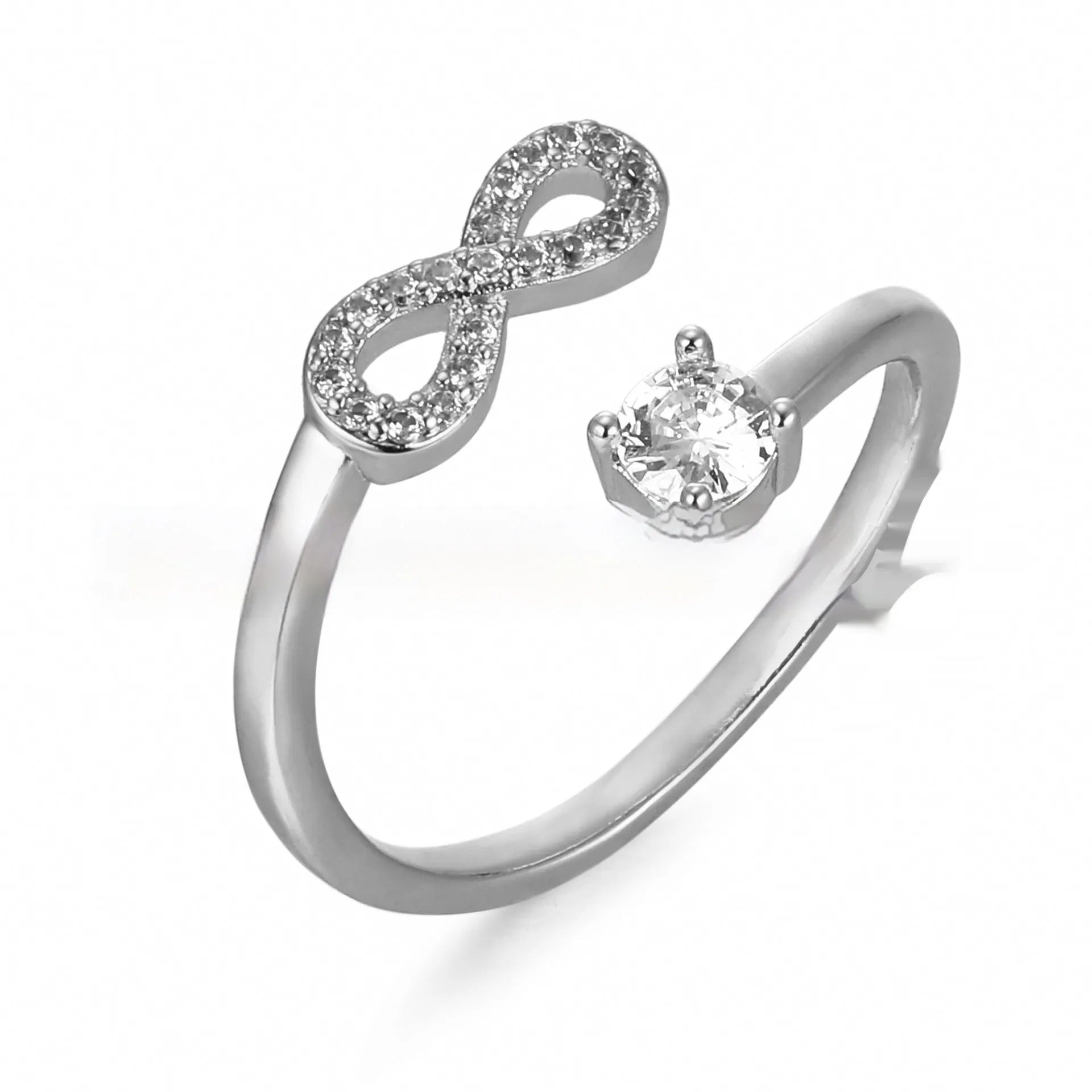 Geometric open zircon ring showing letter personalisation option with inlaid stones and metal construction