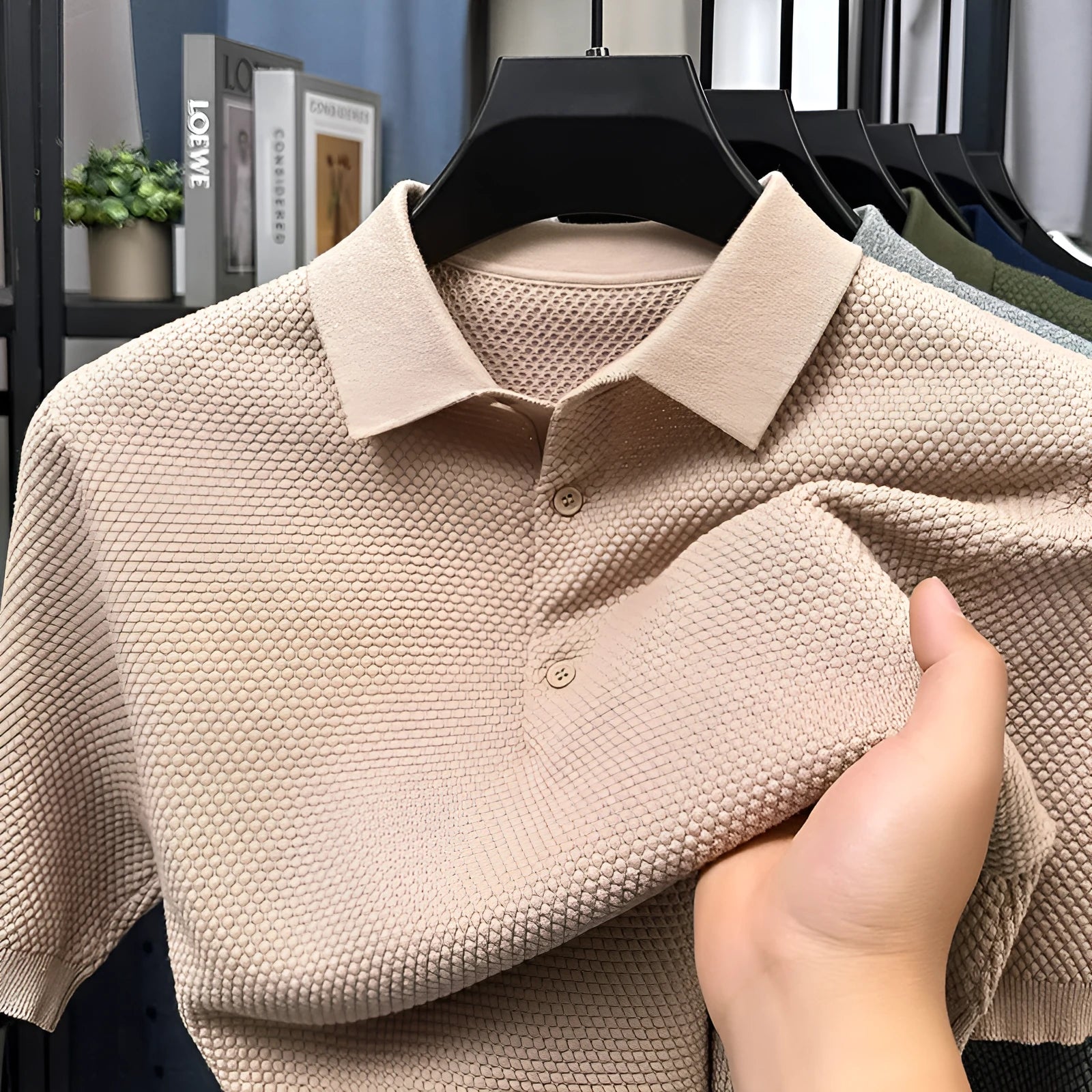 Man wearing a loose navy blue short sleeve cotton pullover sweater casually.