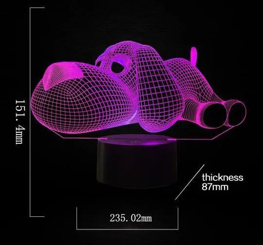 Doggo shaped 3D illusion desktop lamp glowing in multiple colours on a desk.