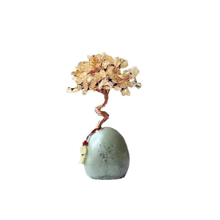 Natural citrine crystal Pachira Macrocarpa lucky ornament on a plain background.