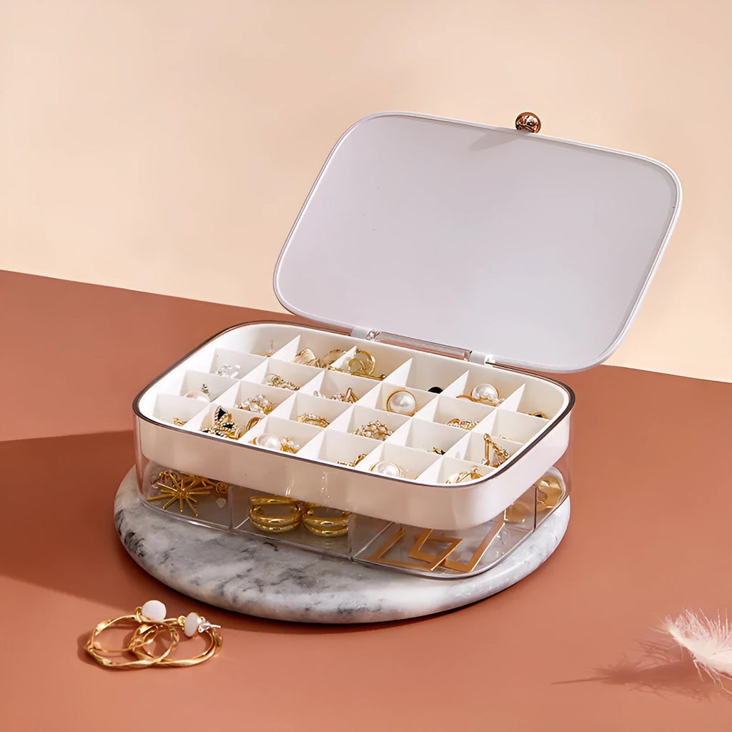 Green minimalist multi-layer jewellery storage box with lid open, showing internal compartments.