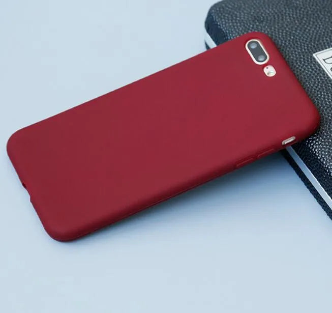 Frosted matte soft-shell iPhone case in multiple colours, shown fitting an iPhone.