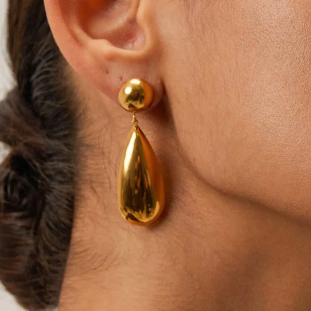 Gold electroplated stainless steel earrings with geometric hemisphere and water drop pendant design