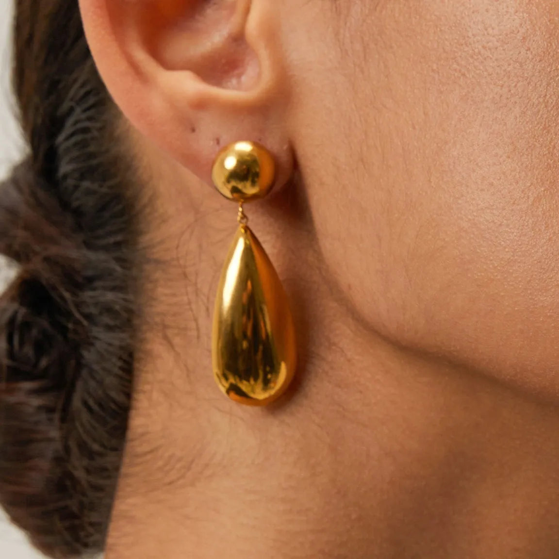 Gold electroplated stainless steel earrings with geometric hemisphere and water drop pendant design