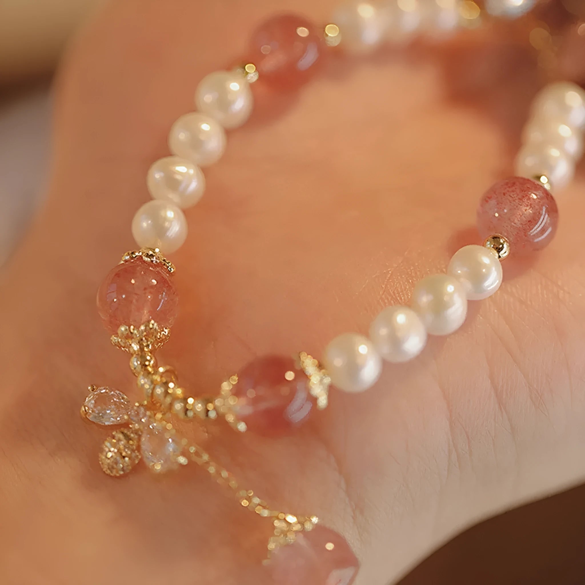 INS style women's bracelet with strawberry quartz stringed pearls and a central bow detail