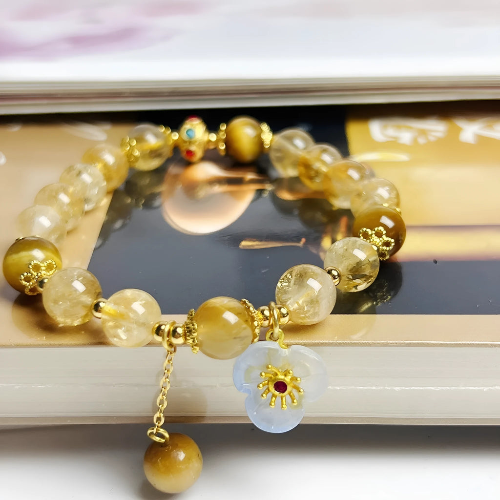 Handcrafted citrine crystal bracelet for women with a flower and tassel design.