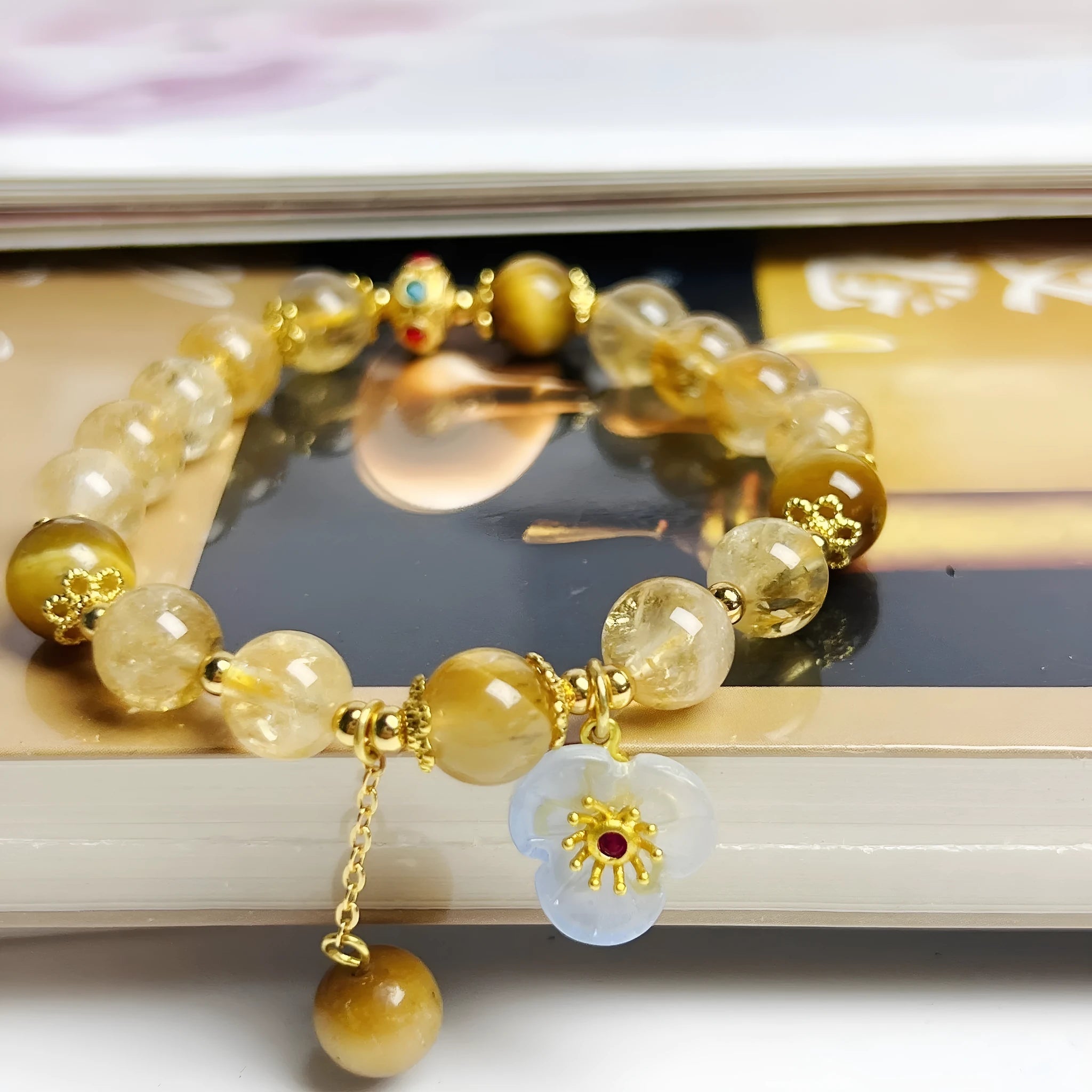 Handcrafted citrine crystal bracelet for women with a flower and tassel design.