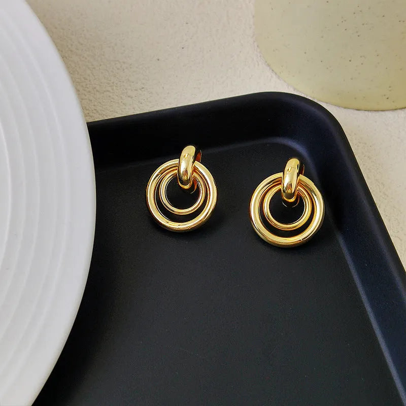 Geometric round ring earrings in gold or silver colour with irregular exotic styling