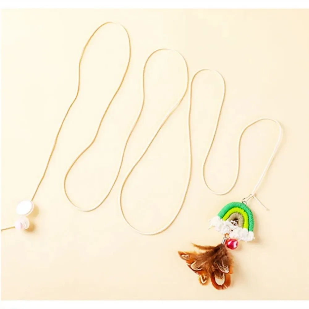 Blue feather cat rope hanging from a door on an elastic swing with a sticky buckle clamp.
