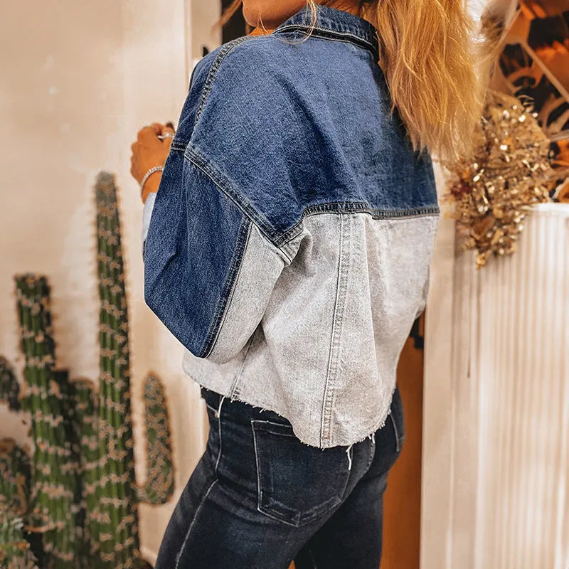 Women's loose fit denim coat with a row of silver buckle closures on the front.