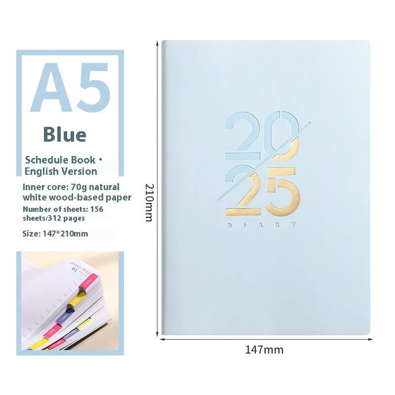 2025 A5 schedule book with faux leather cover in blue, showing open pages on a desk