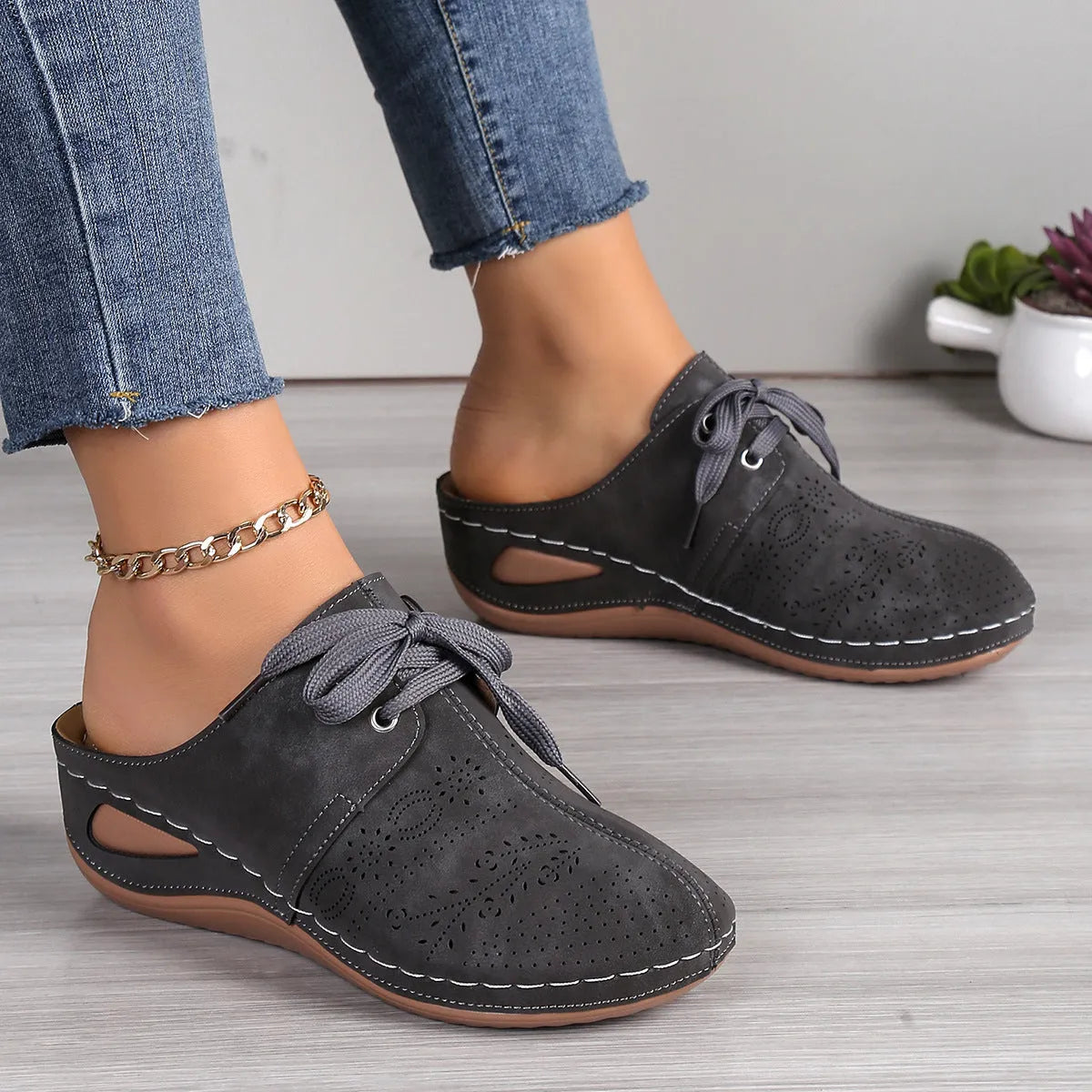 Women's Baotou lace-up slippers with hollow-out wedges in suede upper and rubber sole.