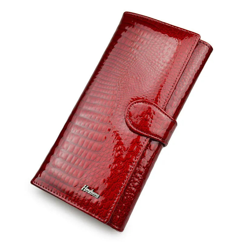 Women's leather purse with crocodile pattern design in wine red colour showing interior pigskin lining