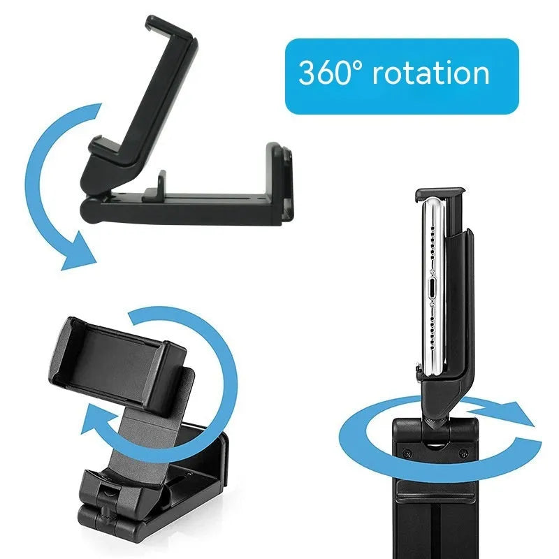 Black 360-degree rotating collapsible phone holder on desktop showing adjustable angle