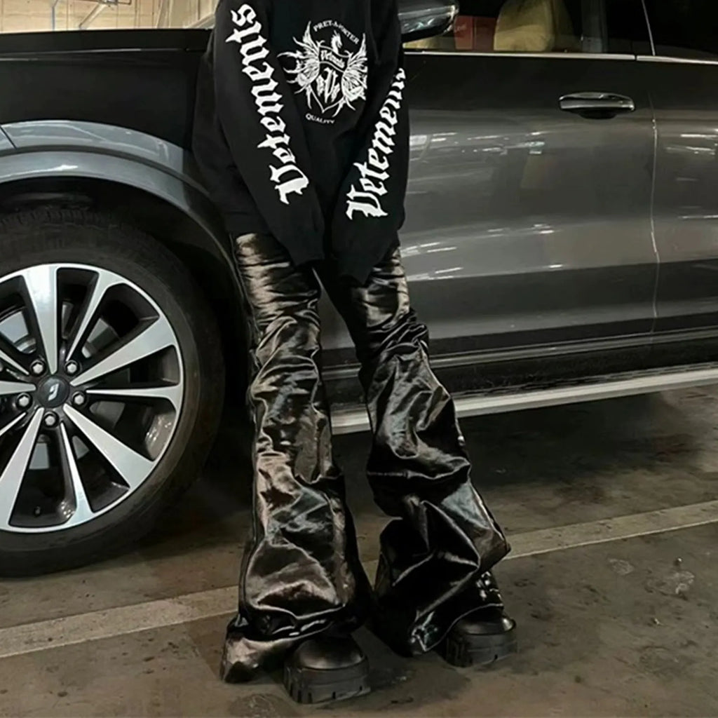 Black coated shiny patent leather skinny jeans with mid-waist straight-leg cut on a model