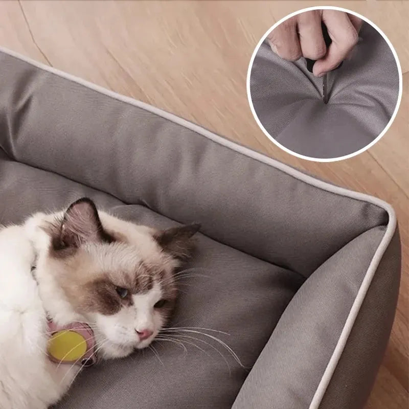 Grey raised cushion dog sofa bed with a waterproof Oxford cloth cover on a wooden floor.