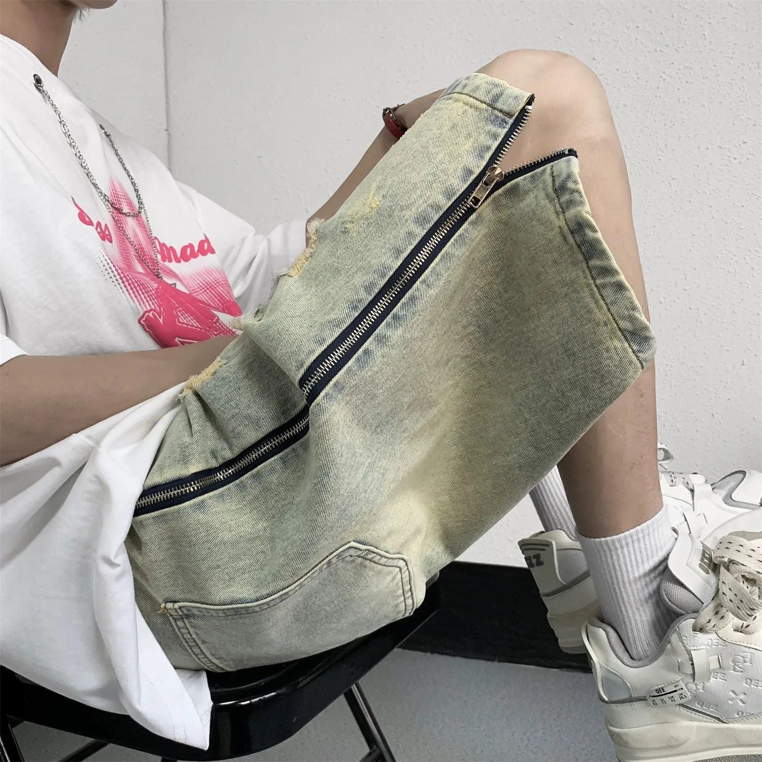 Retro blue men's ripped denim shorts with a loose fit and straight leg opening on a cardigan.