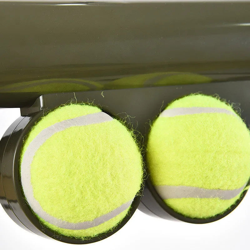 Black ABS plastic dog tennis ball launcher with two tennis balls for long-range throwing