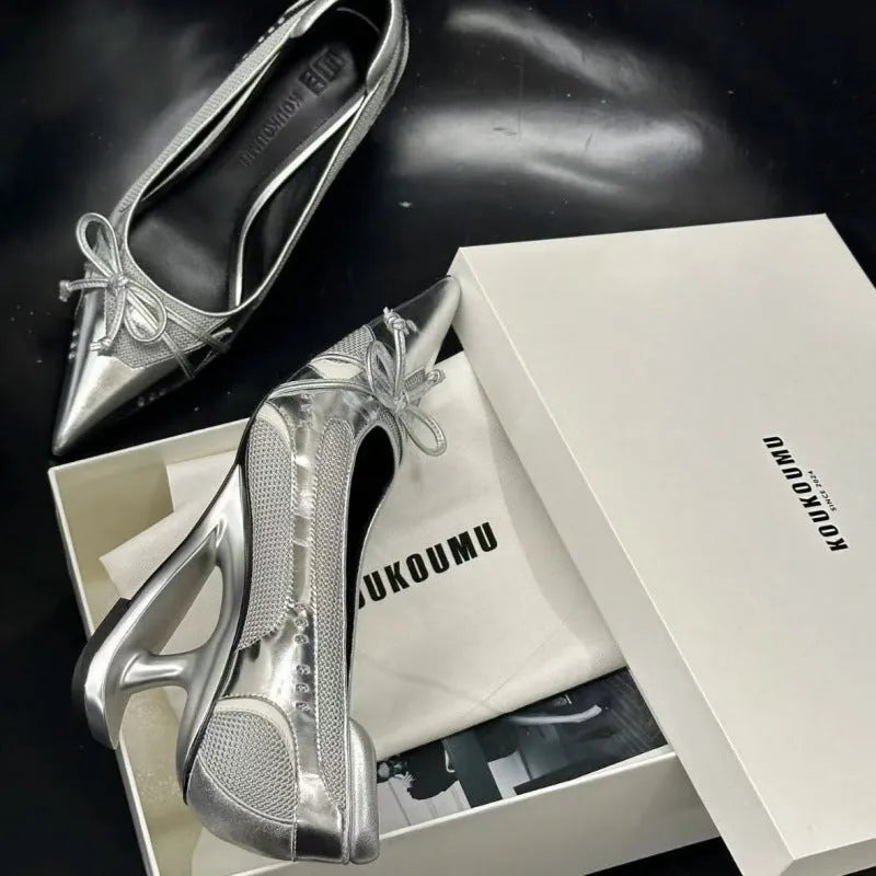 Women's black pointed toe Mary Jane shoes with a unique floating shaped heel