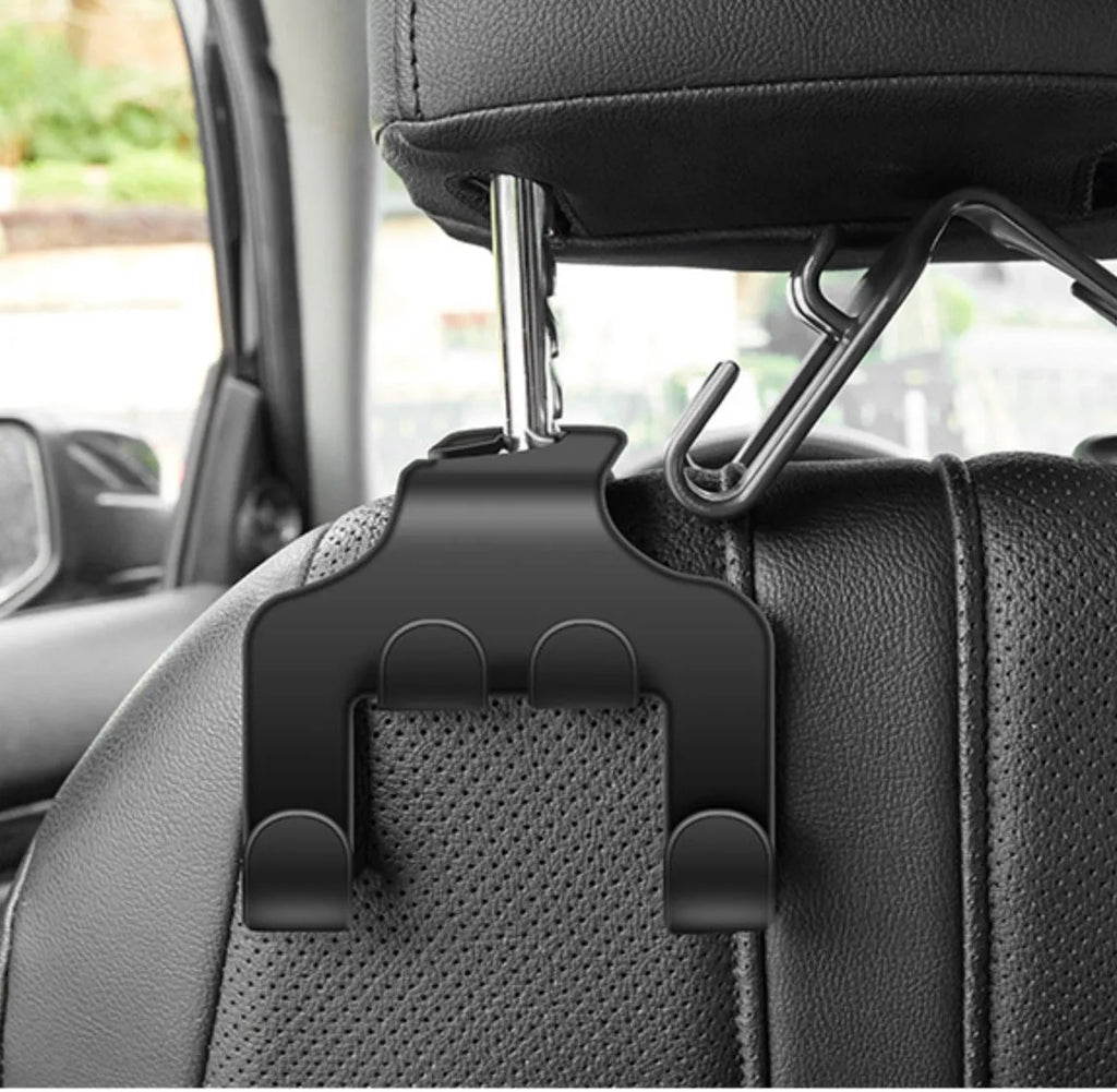 Two white ABS plastic car multifunction holder hooks mounted on a car dashboard.