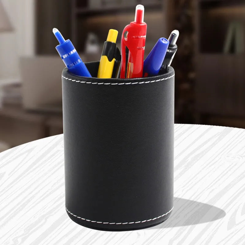 Round black leather pen container measuring 8.0cm diameter and 10.8cm height for desk organisation