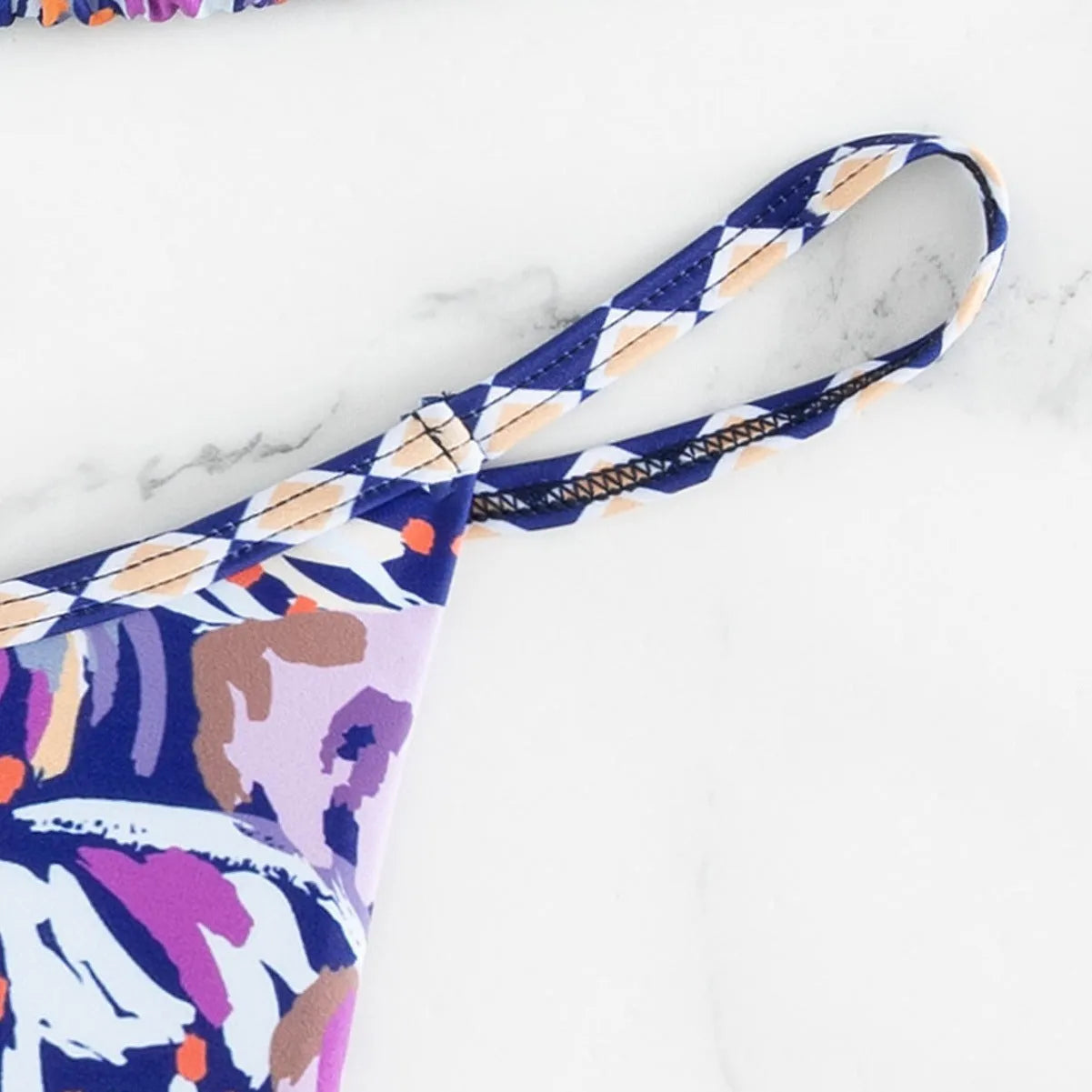 Women's floral print triangle bikini with tie-back and split-front polyester briefs.