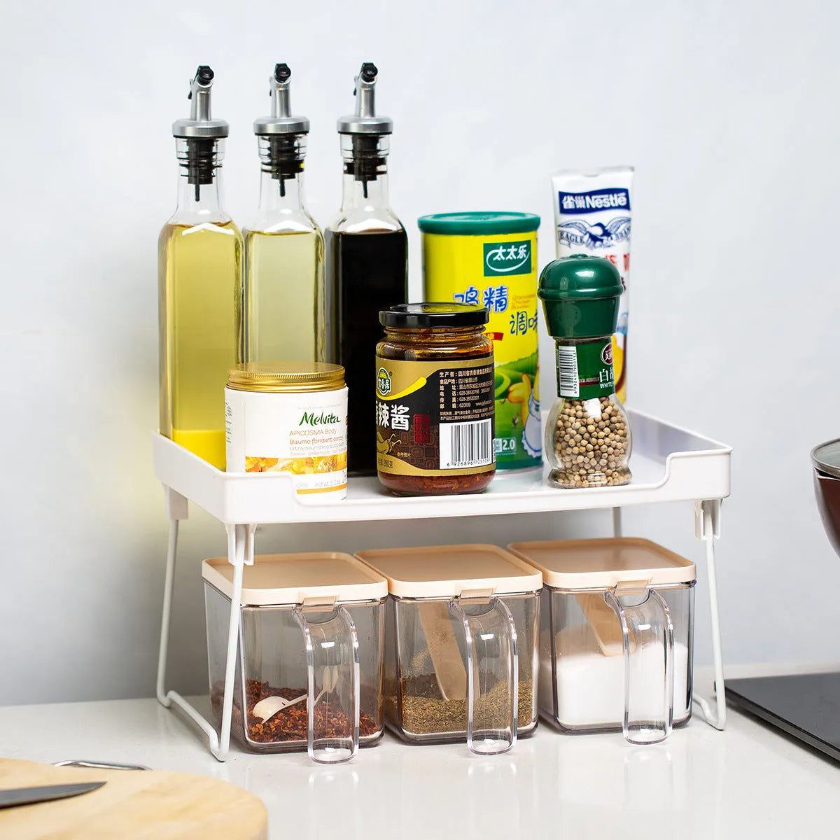 Wall-mounted kitchen supplies rack with adjustable shelves in transparent or white plastic